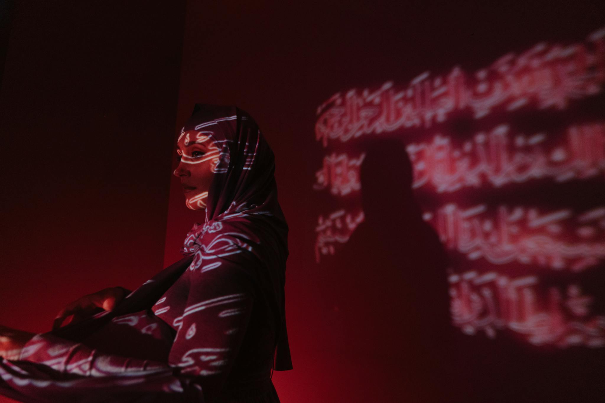artistic projection of arabic scripts on a woman in a hijab exuding mystery and cultural expression. 4646218
