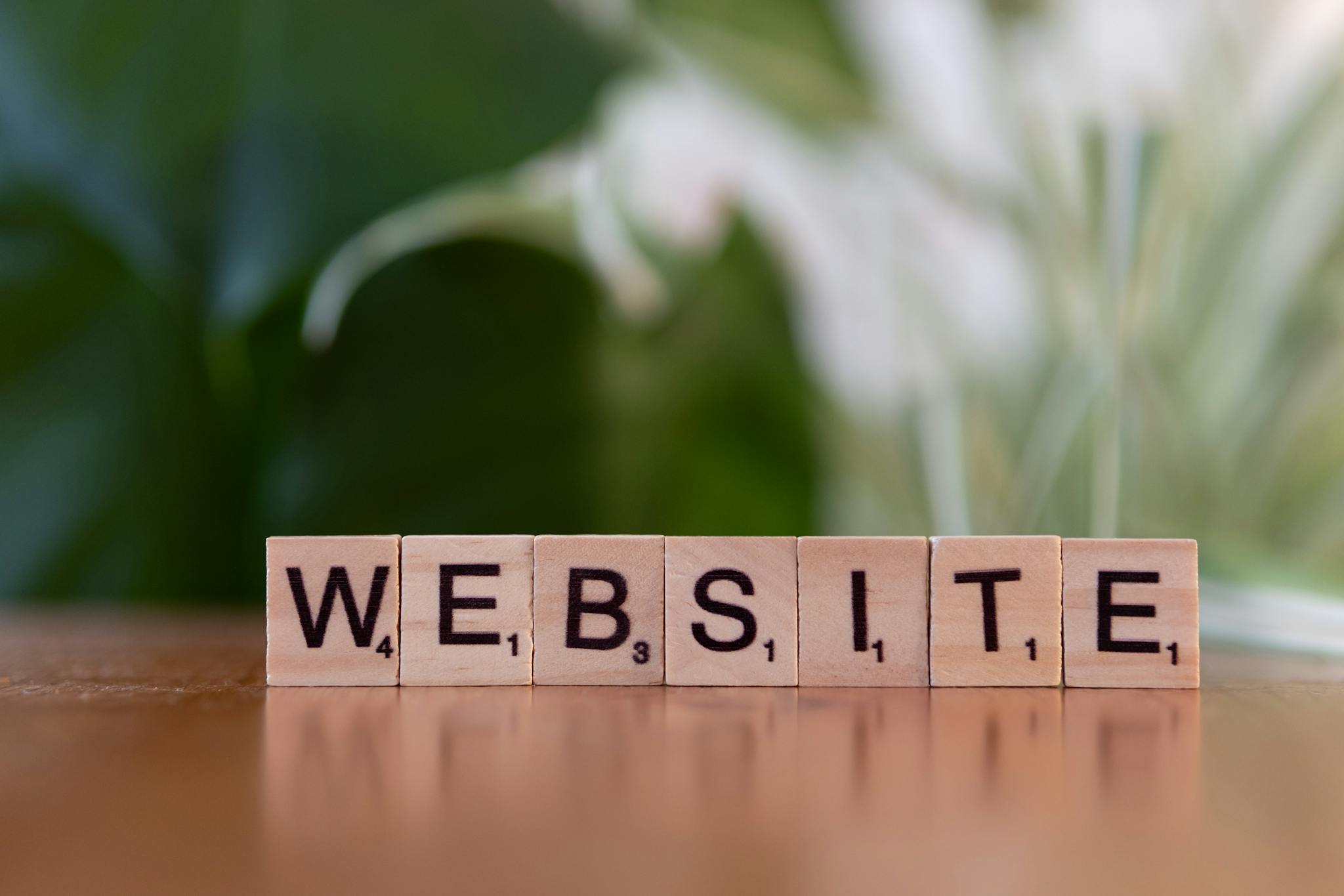 scrabble tiles on a wooden surface forming the word website symbolizing digital communication. 30885764